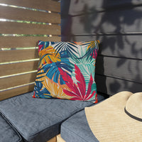 Thumbnail for Colorful leaf-patterned pillow on a gray cushion with a straw hat nearby.