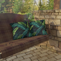 Thumbnail for Wooden swing with green leaf-patterned cushions on a stone patio