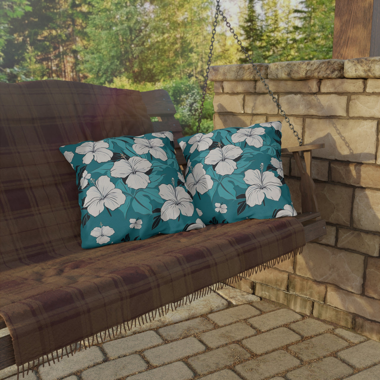 Wooden swing with floral cushions on a stone patio