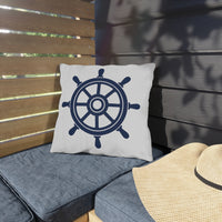 Thumbnail for Pillow with a ship's wheel design on a gray cushioned bench outdoors.