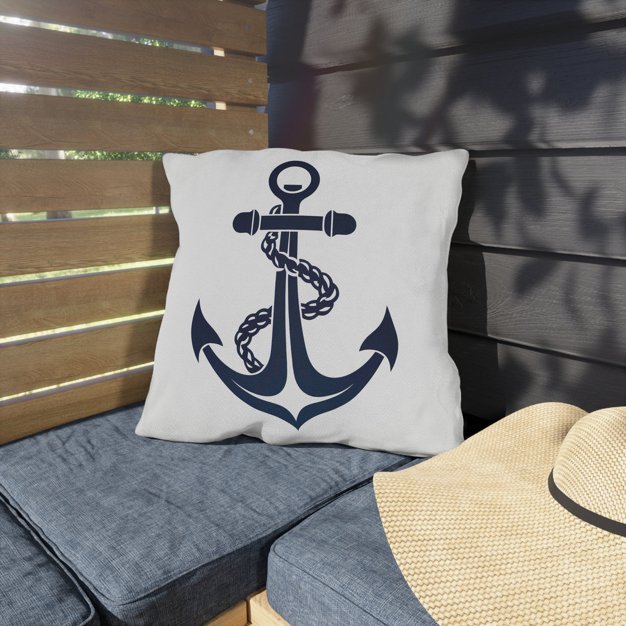 Pillow with anchor design on a bench outdoors