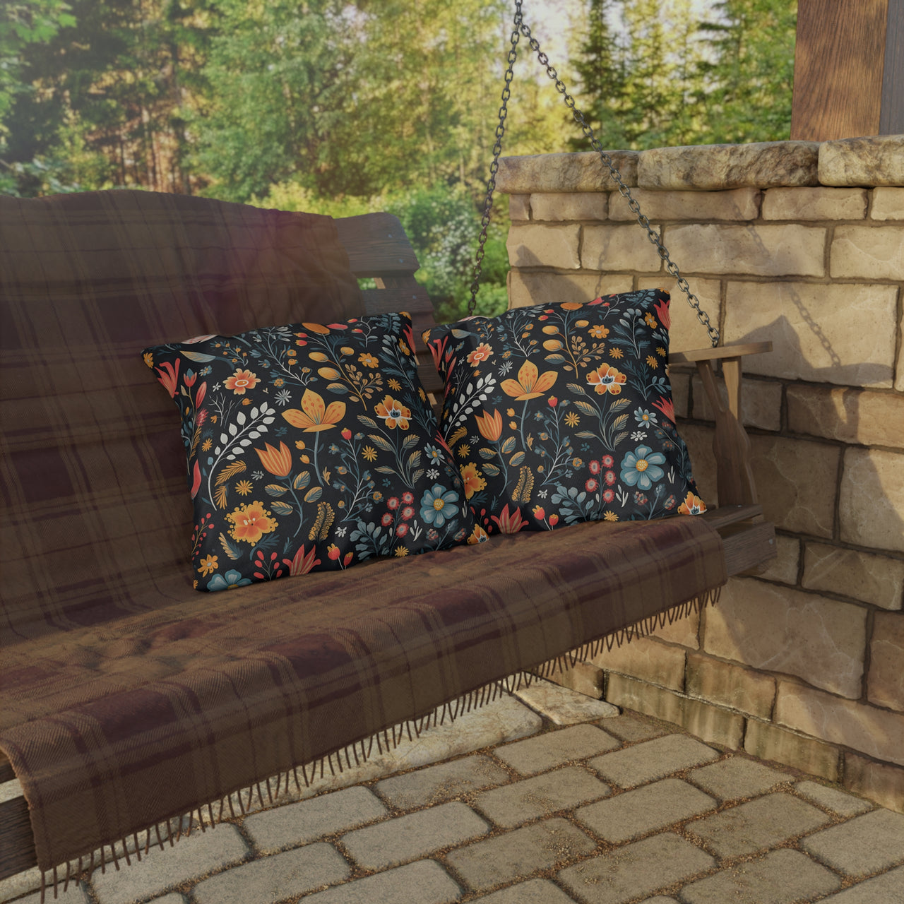 Wooden swing with floral cushions on a stone patio