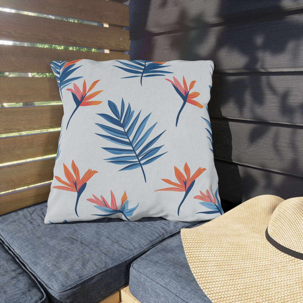 Decorative pillow with tropical leaf pattern on a wooden bench