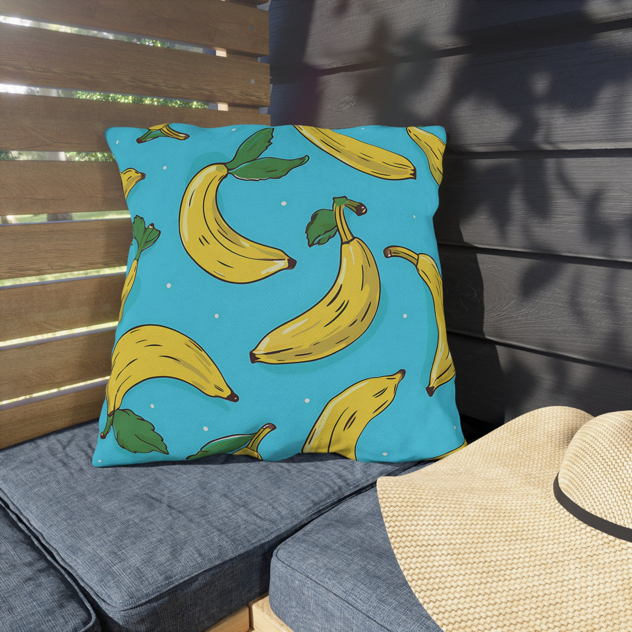 Pillow with banana pattern on a chair outdoors