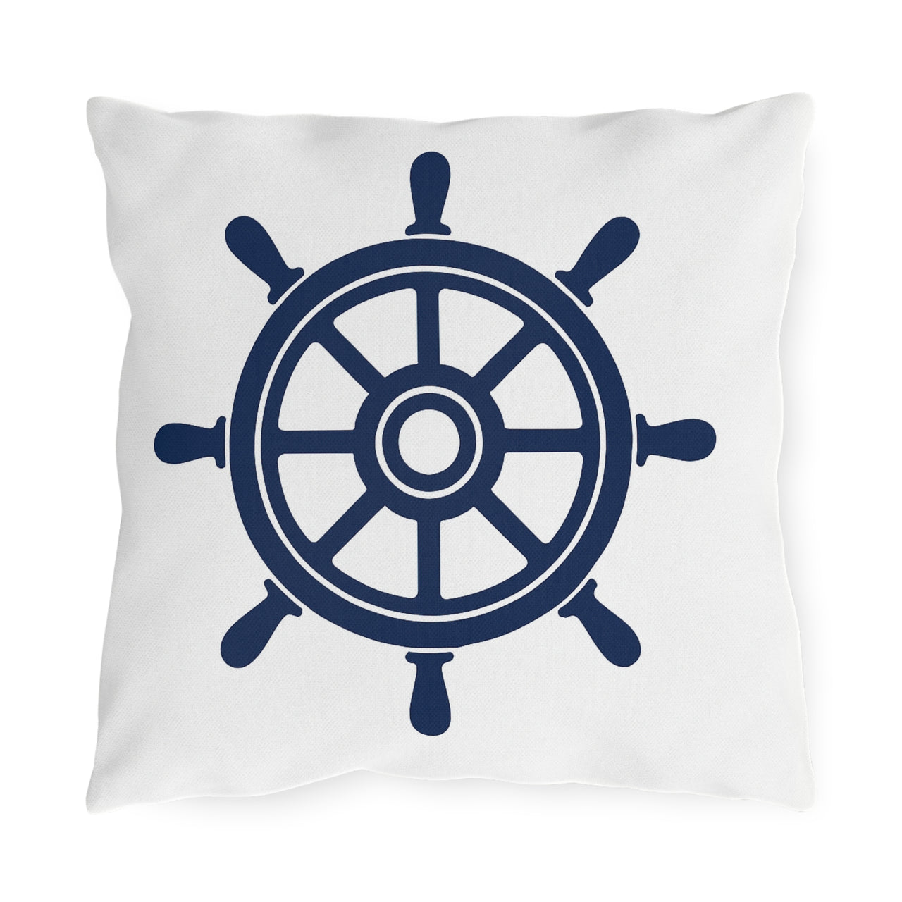 White pillow with a navy blue ship's wheel design on a white background