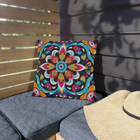 Thumbnail for Colorful patterned pillow on a gray cushion next to a wooden bench and straw hat.