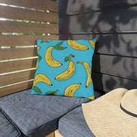 Thumbnail for Pillow with banana pattern on a gray cushion outdoors