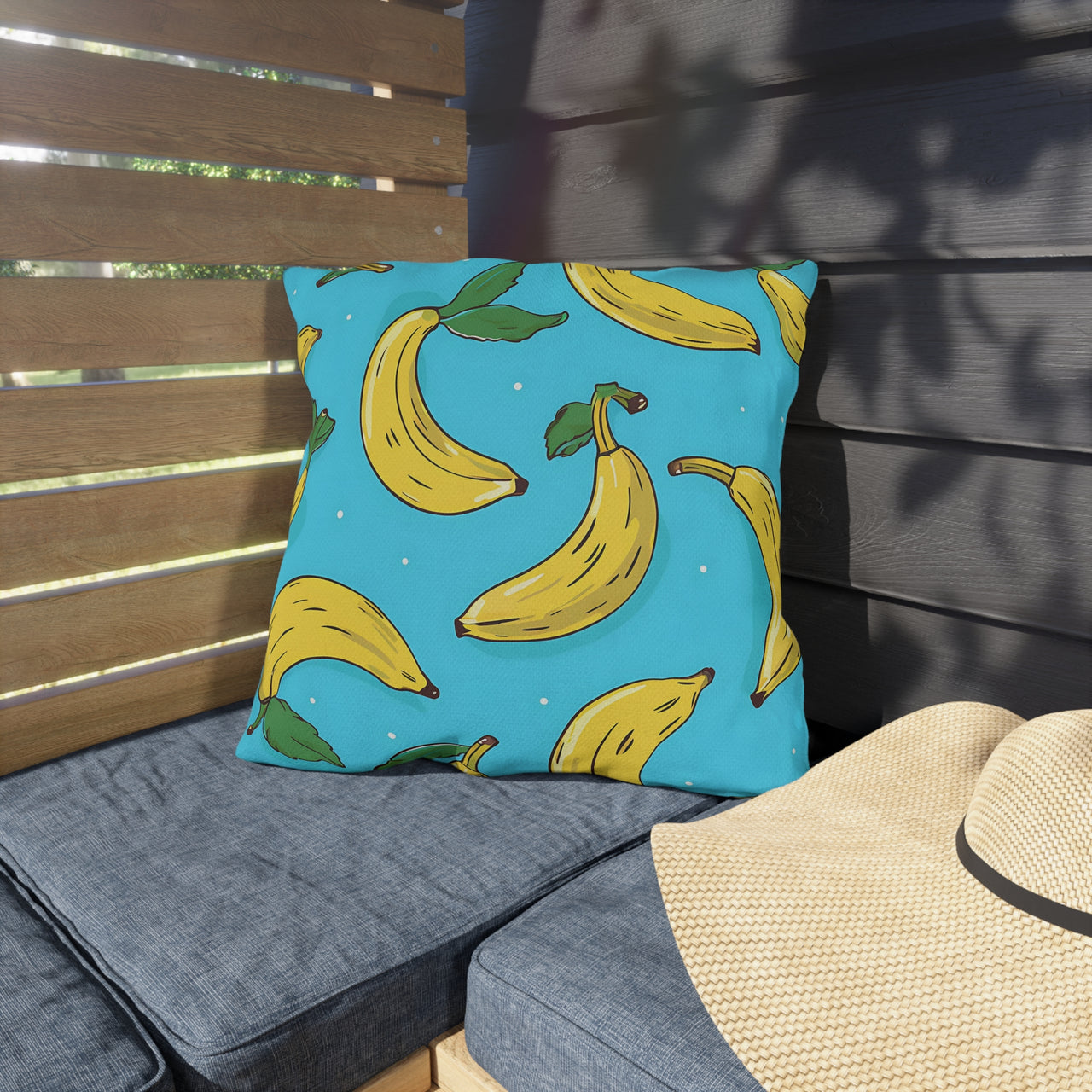 Pillow with banana pattern on a wooden bench