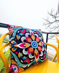 Thumbnail for Colorful patterned cushion on a yellow chair outdoors